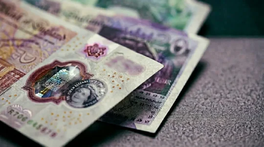 Close-up photograph of British pound sterling banknotes with natural shallow depth of field representing cash savings and financial opportunity